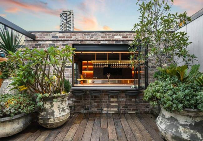 The outdoor entertaining area has a servery window at the bar.