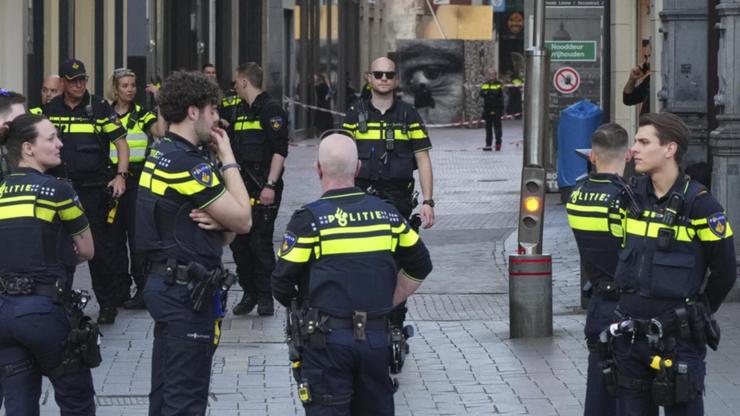Amsterdam police have sealed off large parts of a square as they investigate a car that caught fire. (AP PHOTO)