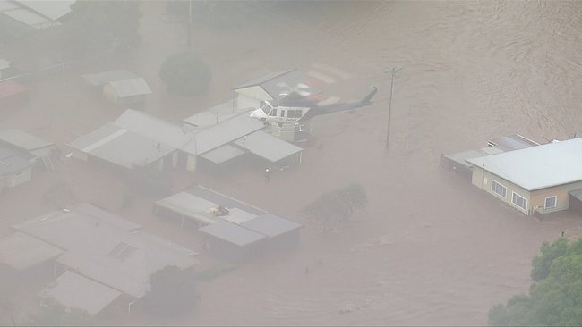 Taree families were stranded on rooftops.