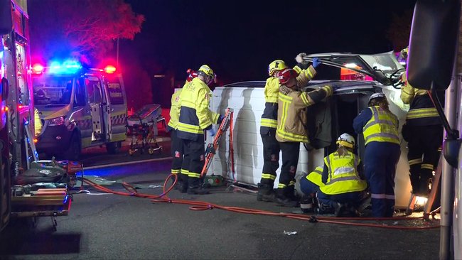 A Toyota van flipped onto its side, trapping the driver.
