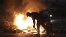 Hundreds of masked rioters have attacked police and set homes and cars on fire in Ballymena.