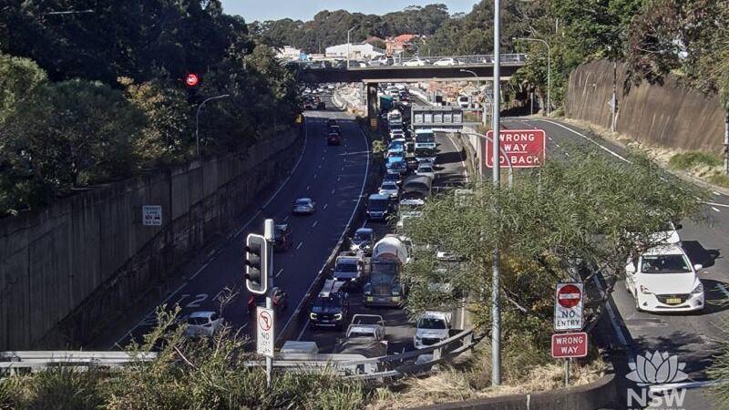 Drivers are urged to avoid the Gore Hill Freeway following a crash involving a car and a motorcycle.